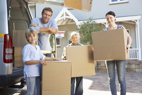 Professional movers handling furniture in a flat near North Finchley