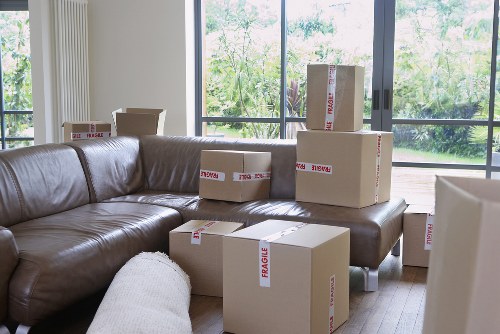 Movers carrying furniture through a North Finchley property